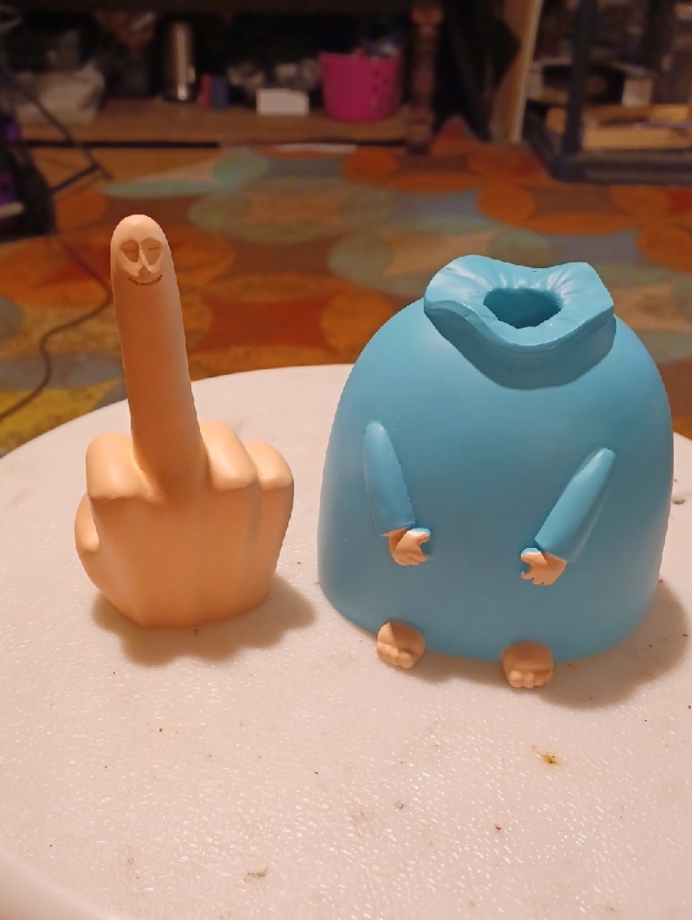 the "Mr. Nice Guy" statue or the "Smiling Middle Finger Statue".